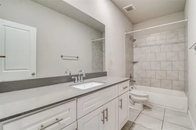 a bathroom with a double vanity sink toilet and shower