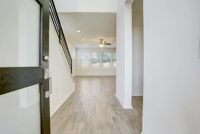 a view of hallway with wooden floor