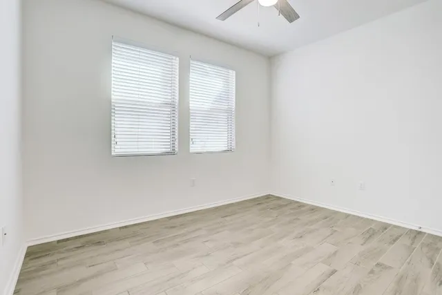 a kitchen with a sink a large window and wooden floor