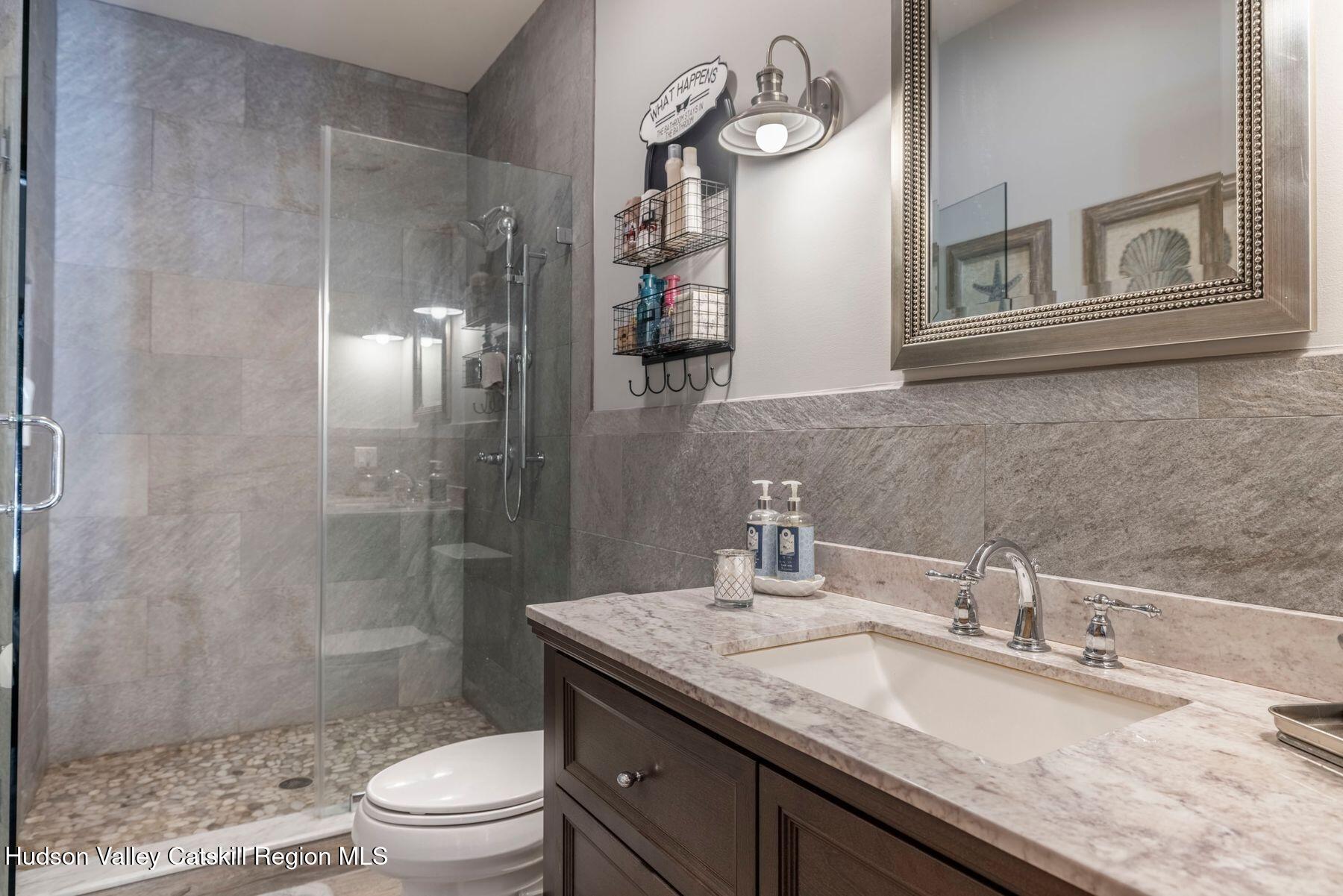 85 Conifer Lake Road West Jewett, NY 12444 - Photo 19 of 50 a bathroom with a granite countertop sink a toilet and shower
