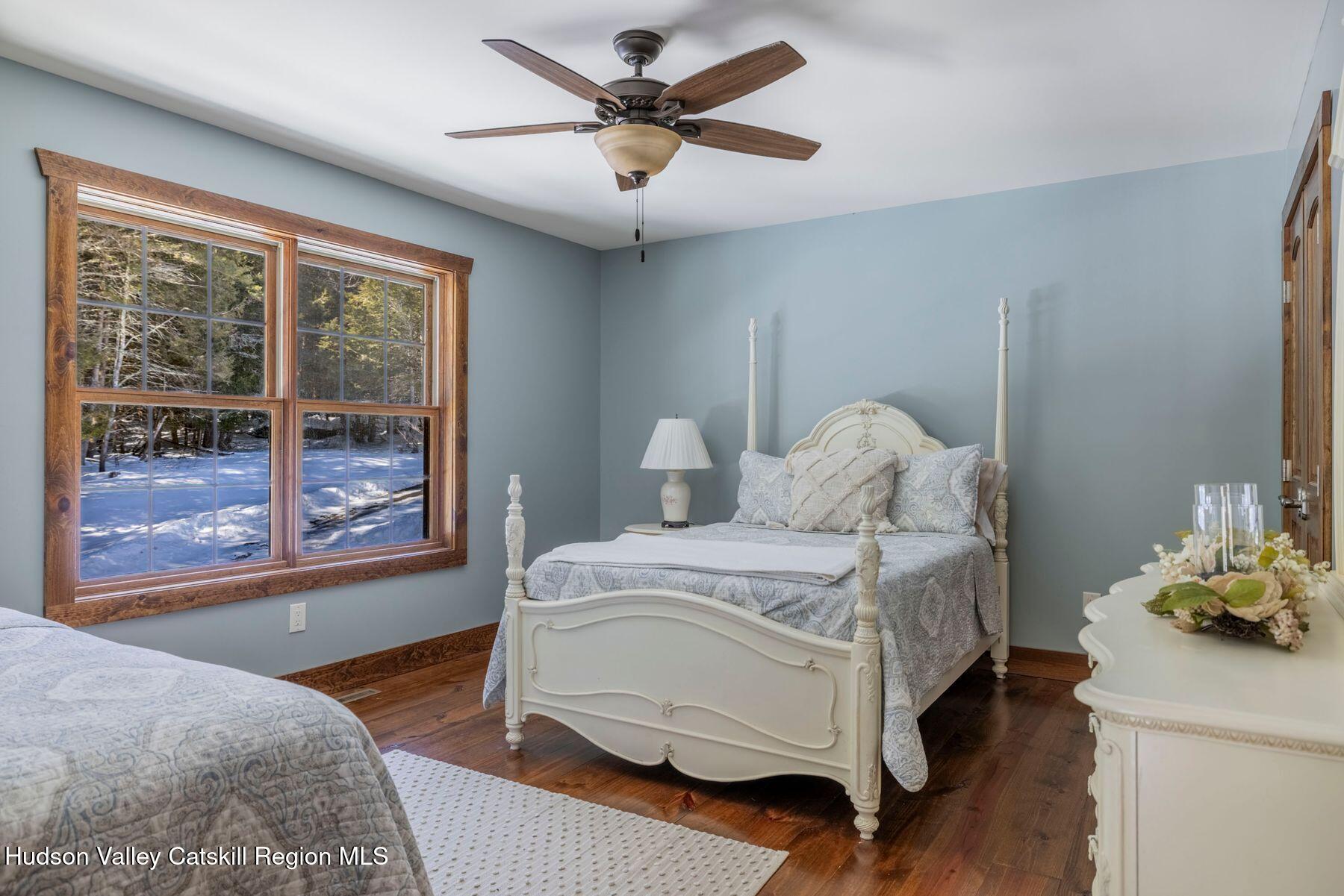 85 Conifer Lake Road West Jewett, NY 12444 - Photo 25 of 50 a bedroom with a bed table and a window