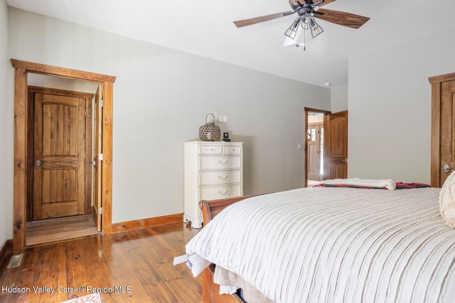 85 Conifer Lake Road West Jewett, NY 12444 - Photo 26 of 50 a bedroom with a bed and a chandelier
