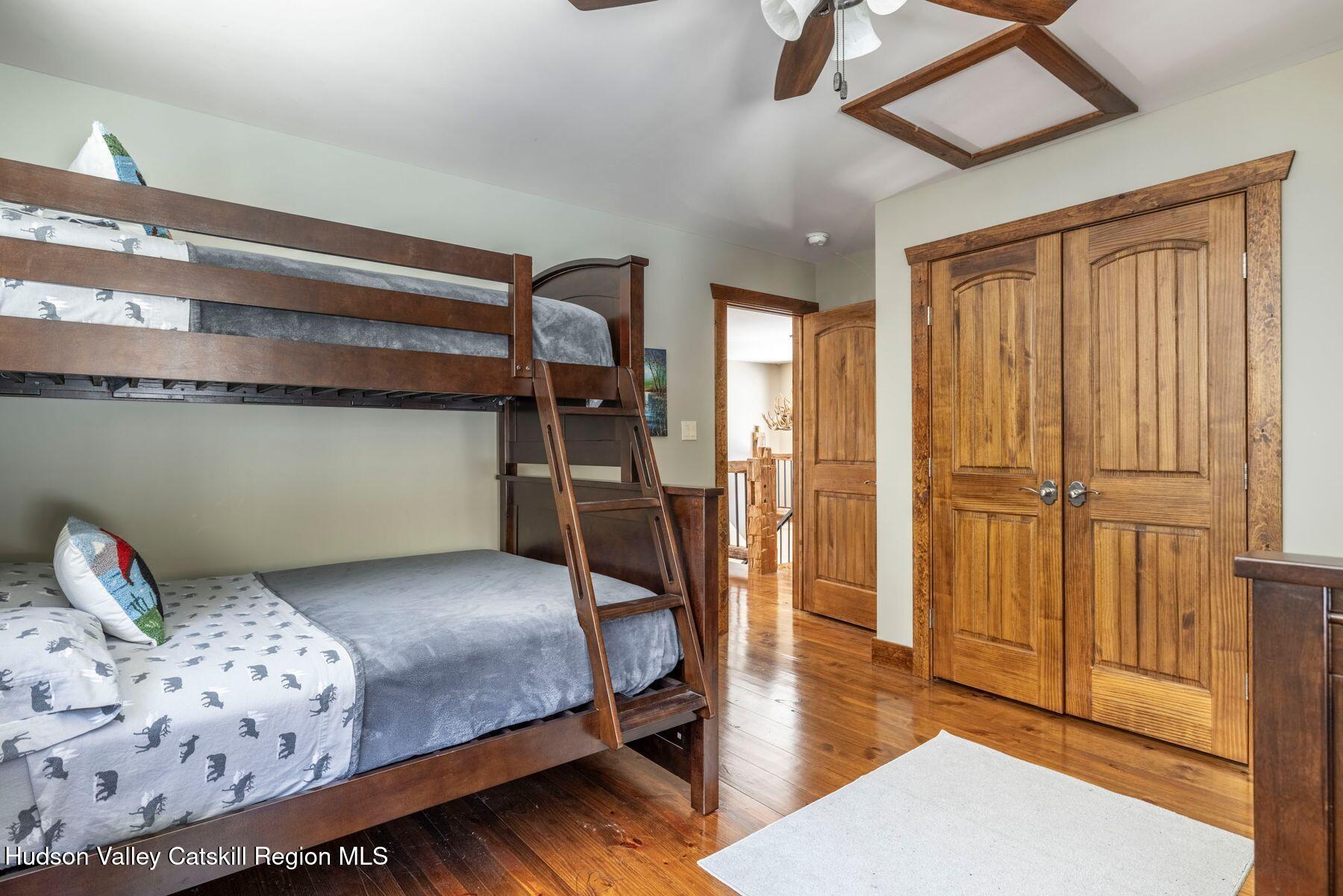 85 Conifer Lake Road West Jewett, NY 12444 - Photo 27 of 50 a bedroom with a bed and wooden floor