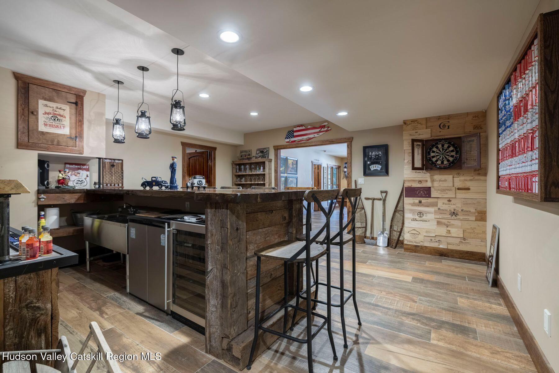 85 Conifer Lake Road West Jewett, NY 12444 - Photo 35 of 50 a kitchen with stainless steel appliances granite countertop a stove top oven a dining table and chairs with wooden floor