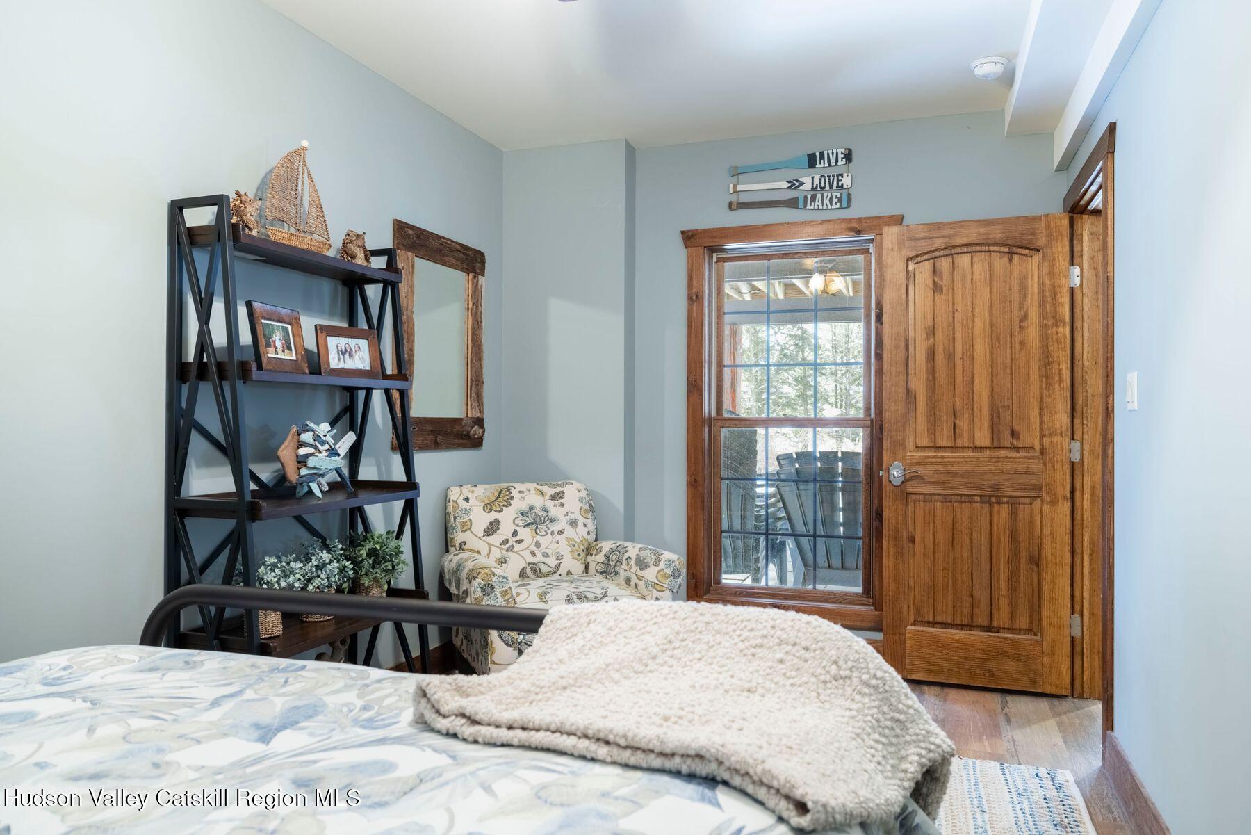 85 Conifer Lake Road West Jewett, NY 12444 - Photo 37 of 50 a bedroom with a bed and wooden floor