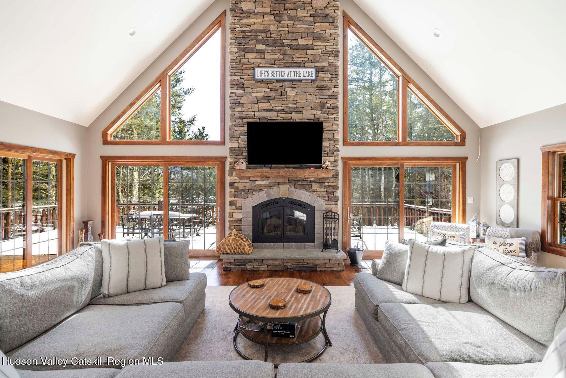 85 Conifer Lake Road West Jewett, NY 12444 - Photo 9 of 50 a living room with furniture a fireplace and a large window