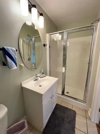 a bathroom with a sink mirror and toilet