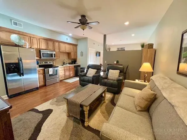 a living room with furniture and a wooden floor