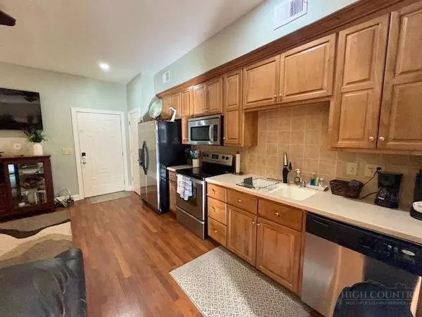 a kitchen with a sink cabinets and appliances