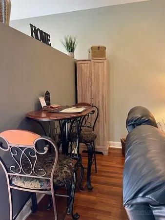 a dining room with furniture and wooden floor