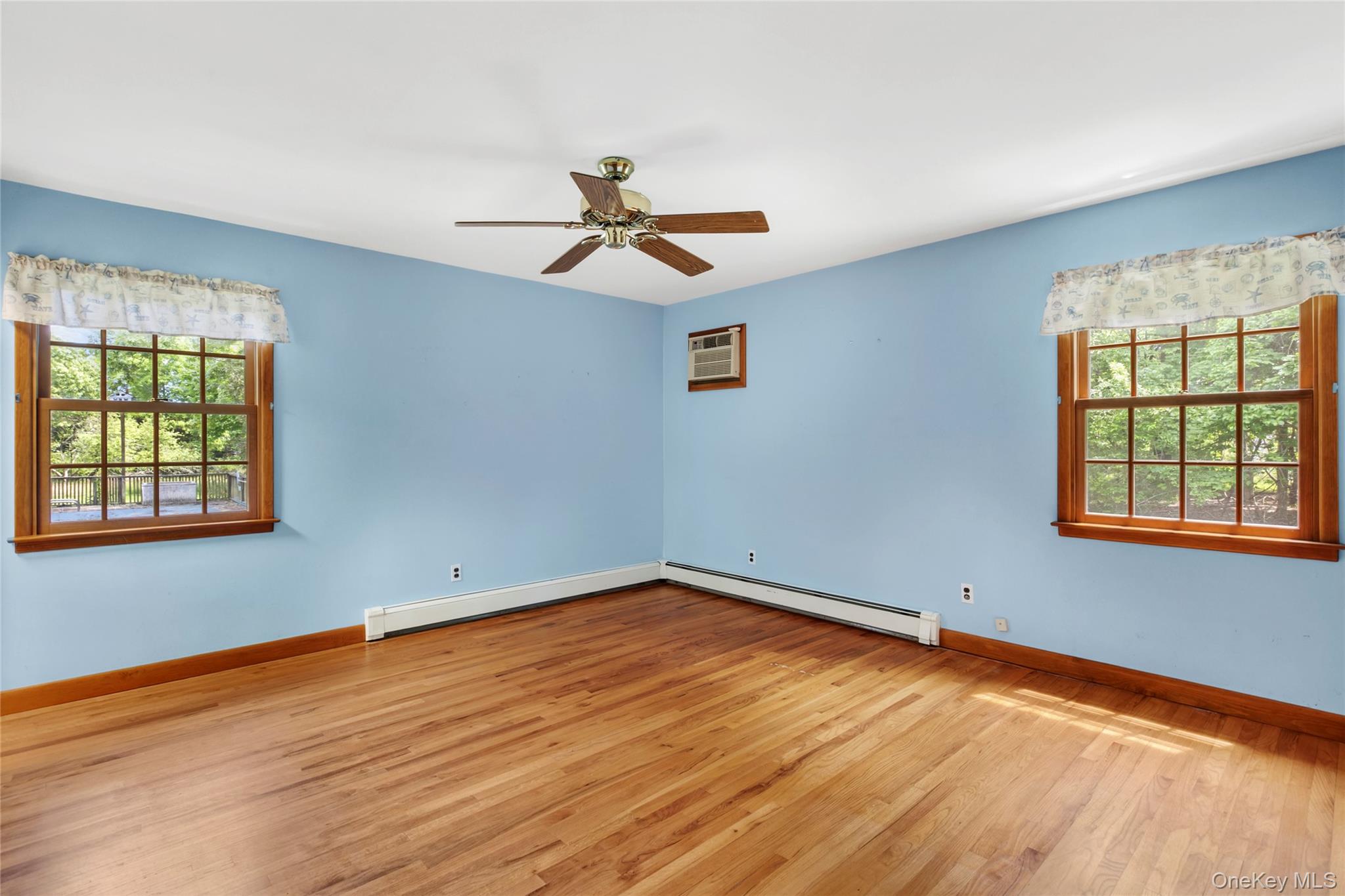 250 Paradise Point Road Southold, NY 11971 - Photo 9 of 24 a view of empty room with wooden floor and fan
