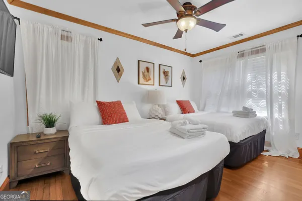 a kitchen with stainless steel appliances granite countertop a stove a refrigerator and a dining table with wooden floor