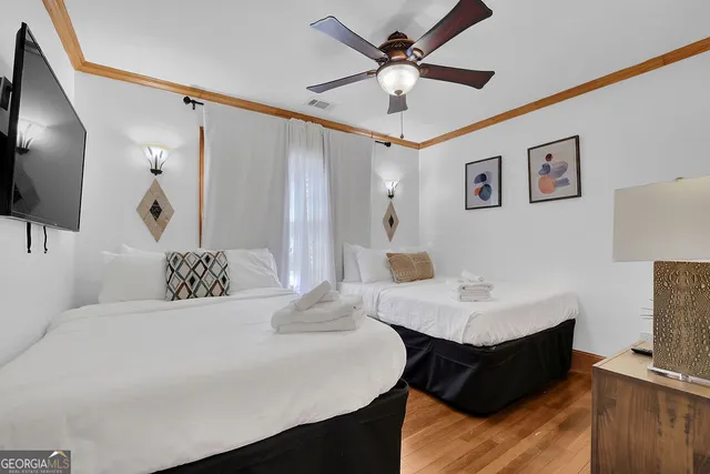 a bedroom with bed and wooden floor