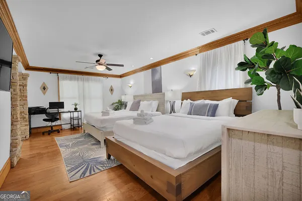 a bedroom with a bed and a flat screen tv