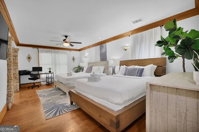 a bedroom with a bed and a flat screen tv