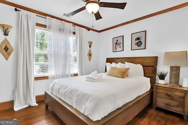 a dining room with furniture window and wooden floor