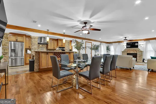 a kitchen with stainless steel appliances granite countertop a stove a sink and a refrigerator