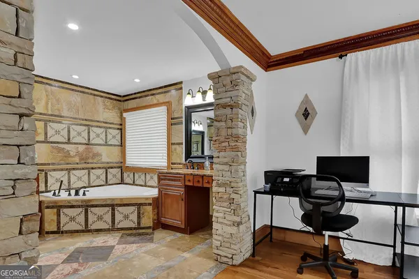 a living room with furniture a fireplace and a large window