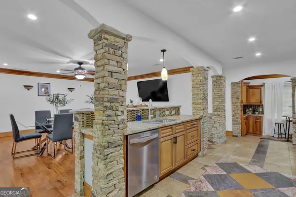 a view of a backyard with plants and large trees