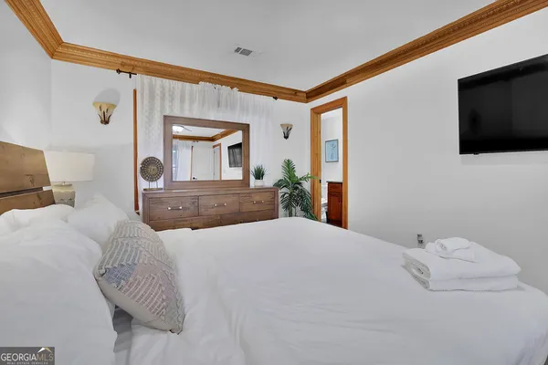 a bedroom with a bed and a chandelier