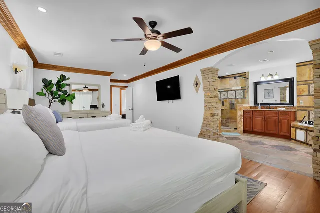 a living room with a bed furniture and a flat screen tv