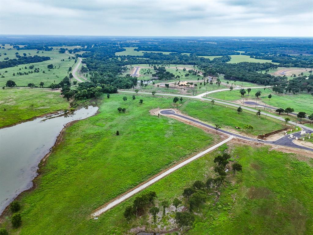 204 Lakeshore Lane Windom, TX 75492 - Photo 27 of 40 Aerial view of property and surrounding area featuring rural landscape and a nearby body of water