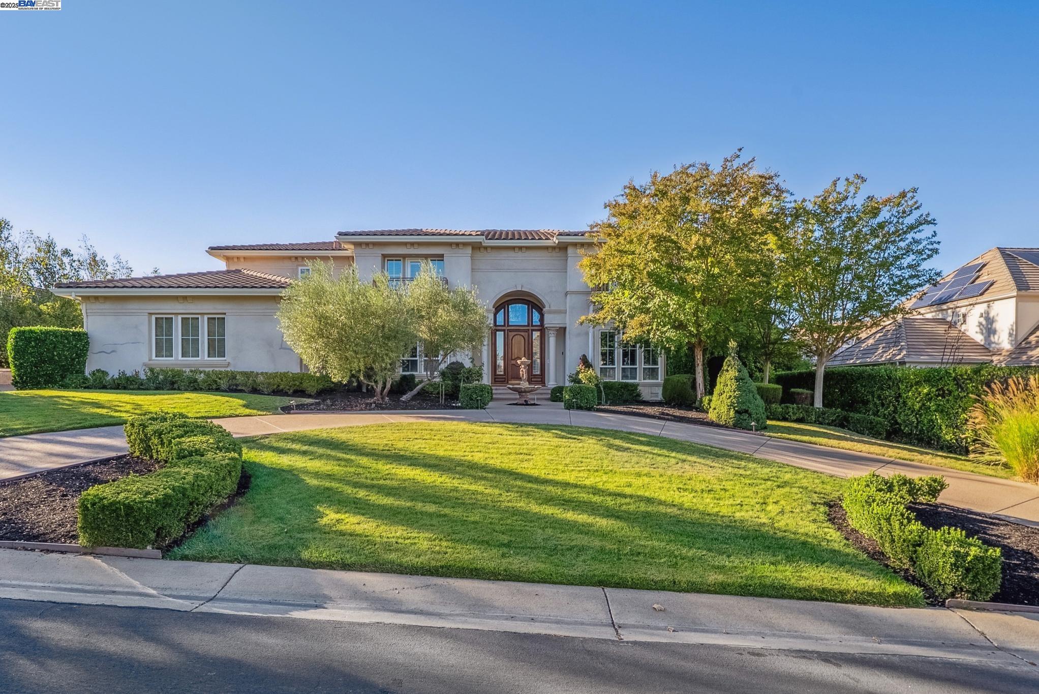 a front view of a house with swimming pool having outdoor seating