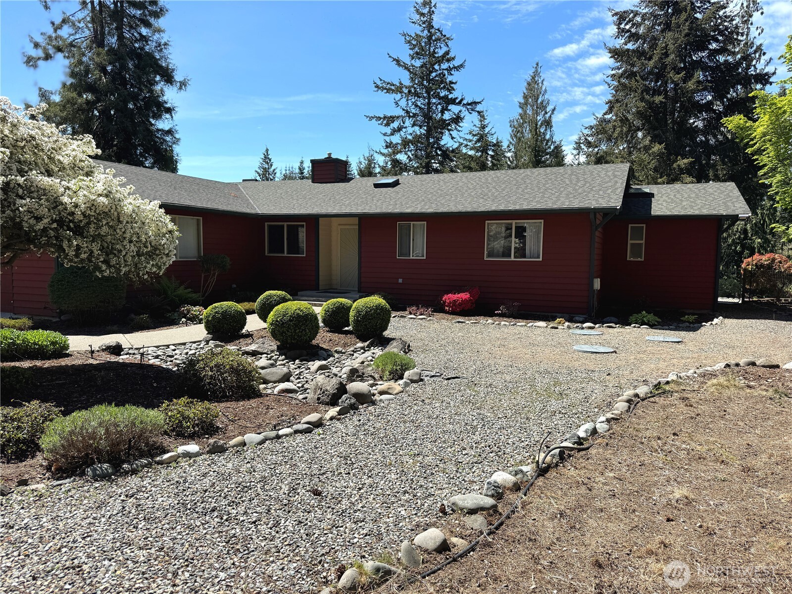 a front view of a house with a yard covered with snow