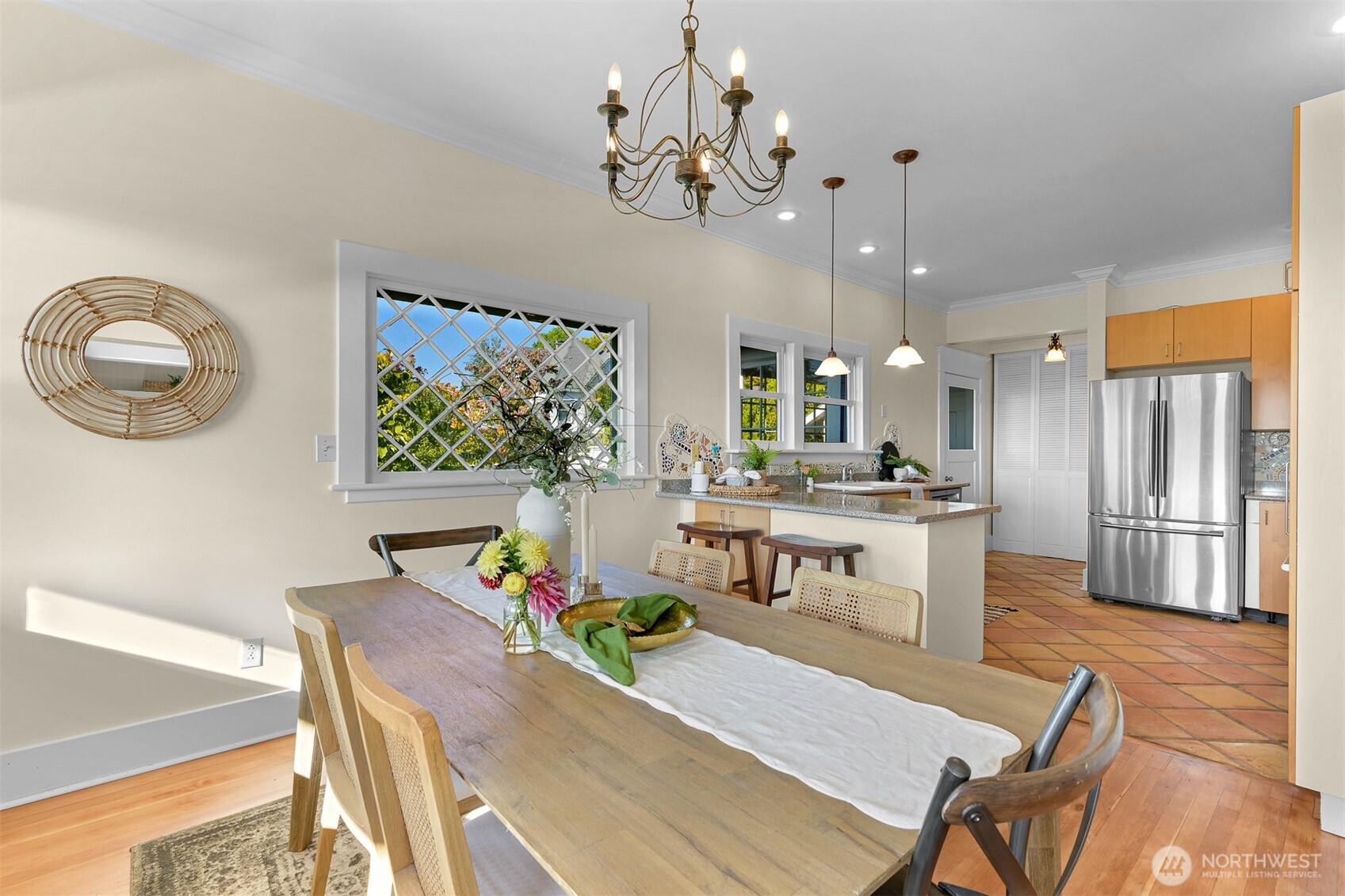 903 13th Street Bellingham, WA 98225 - Photo 19 of 40 a living room with kitchen island dining table and a chandelier