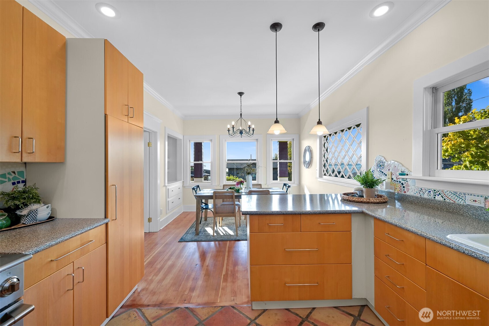 903 13th Street Bellingham, WA 98225 - Photo 21 of 40 a view of a kitchen with kitchen island stainless steel appliances a sink cabinets and a counter top space