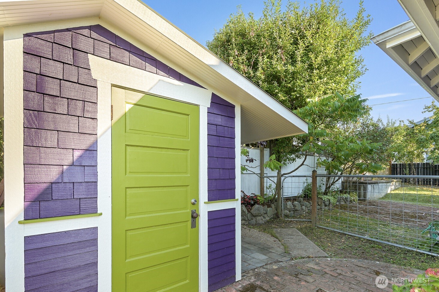 903 13th Street Bellingham, WA 98225 - Photo 37 of 40 a backyard of a house with a fountain and potted plants