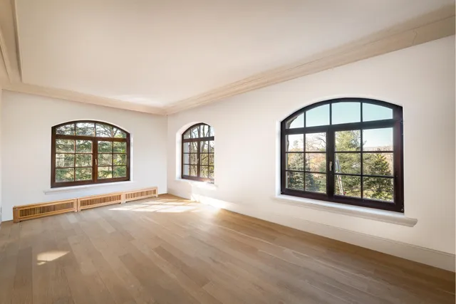 a large white kitchen with a large window