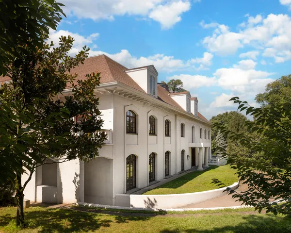 a bedroom with a bed and lamp