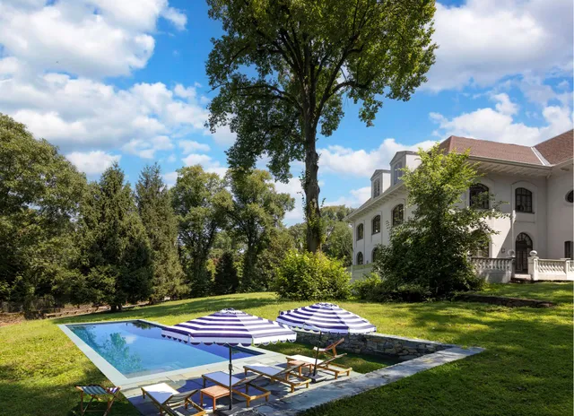 a view of a white house with a yard