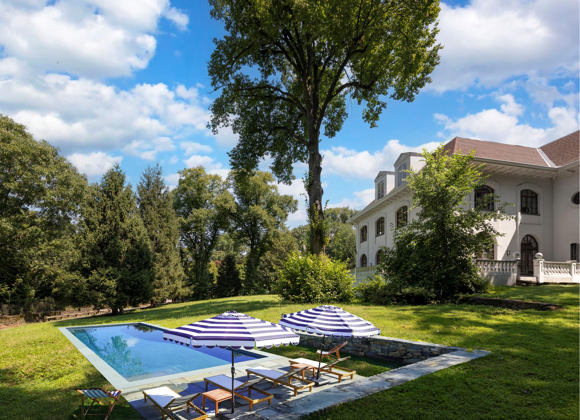 5040 Independence Avenue Bronx, NY 10471 - Photo 22 of 27 a view of swimming pool with lawn chairs and plants