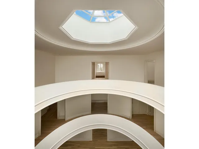 a bedroom with a bed and a large mirror