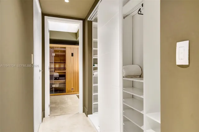 a large bedroom with a bed and glass door