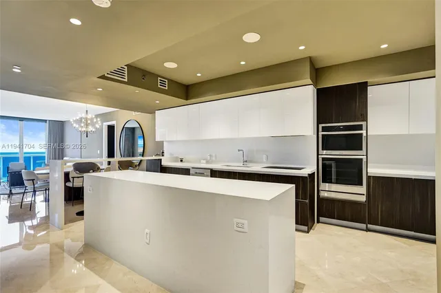 a kitchen with stainless steel appliances kitchen island granite countertop a sink and cabinets