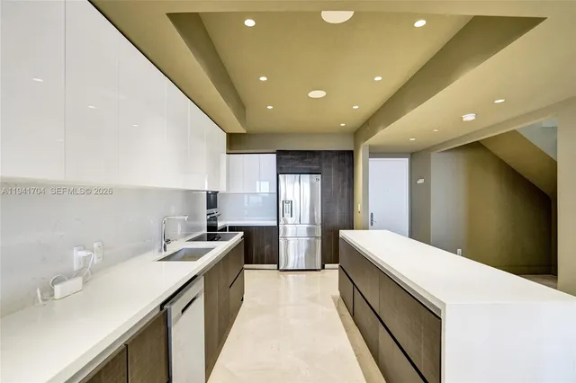 a kitchen with stainless steel appliances kitchen island granite countertop a sink and cabinets