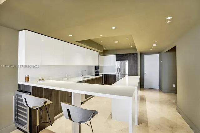a kitchen with a dining table cabinets and appliances