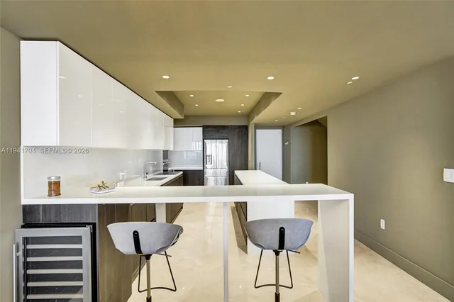 a view of a dining room with furniture and a chandelier