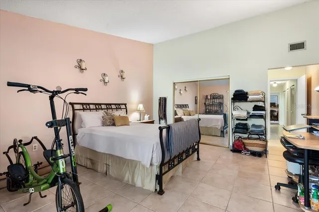 a bed room with a bed and a chair