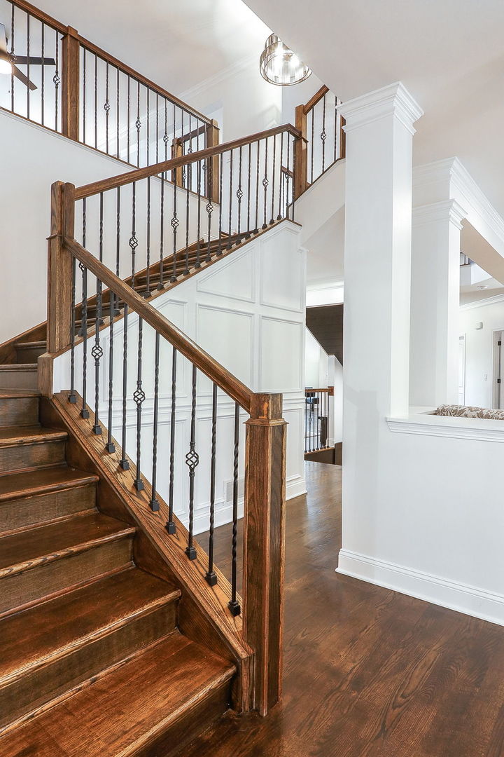 335 Forest Trail South Elgin, IL 60177 - Photo 21 of 47 a view of staircase with lots of frames on wall and wooden floor