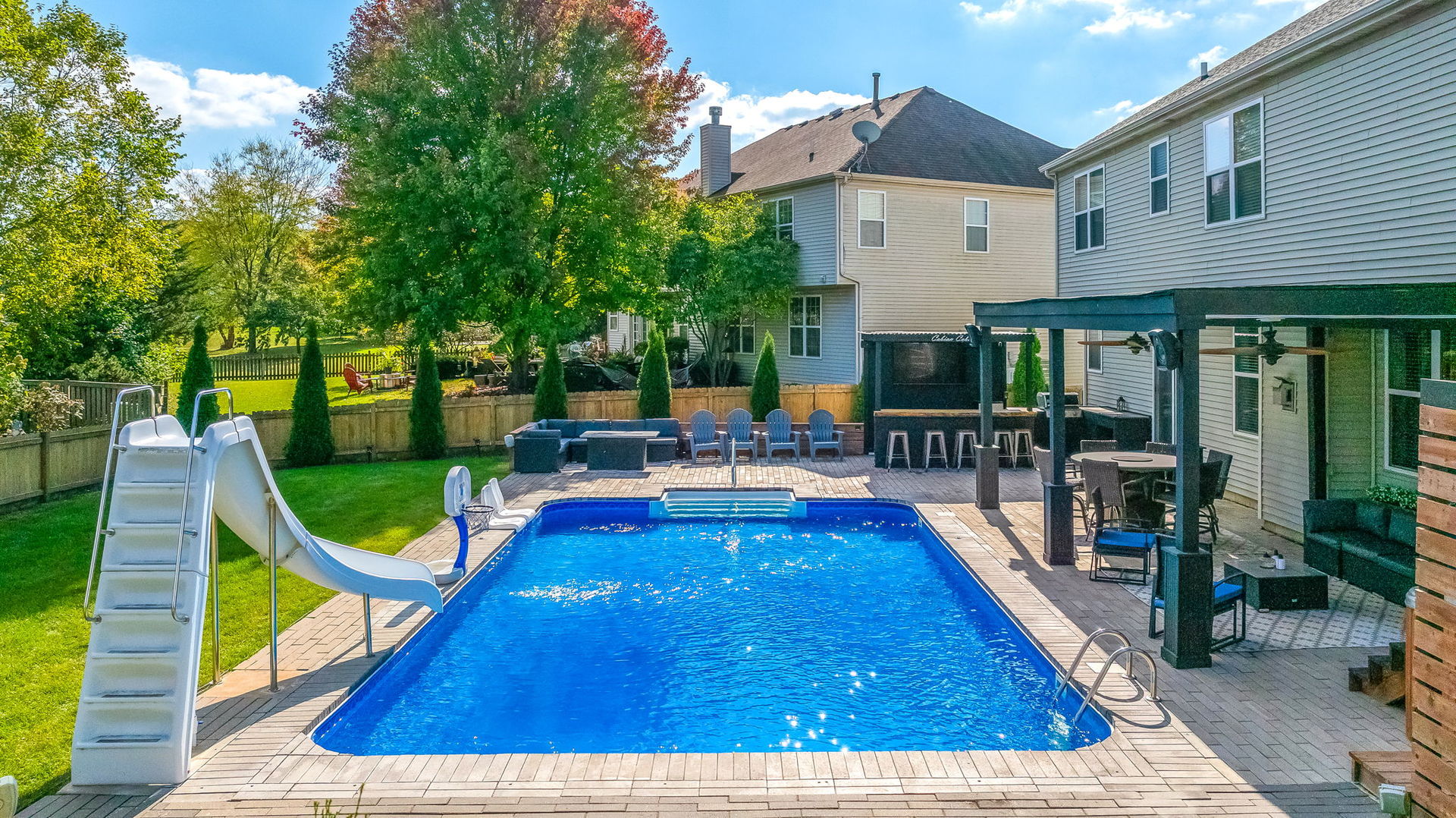 335 Forest Trail South Elgin, IL 60177 - Photo 39 of 47 a view of swimming pool with lounge chair and dinning table under an umbrella
