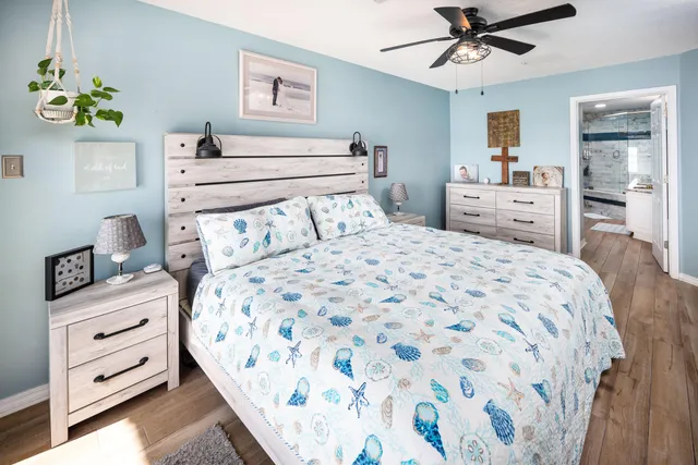 a bathroom with a granite countertop sink a toilet and shower