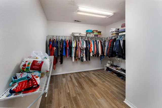 a bathroom with a granite countertop sink a mirror and a shower