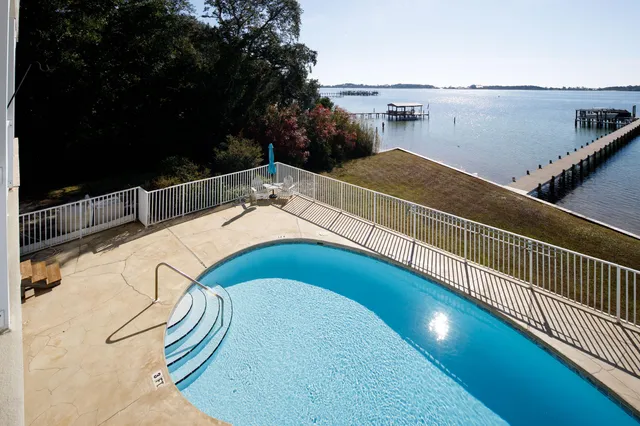 a view of a room with furniture and wooden floor