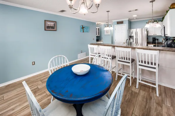 a kitchen with kitchen island a refrigerator and a stove top oven