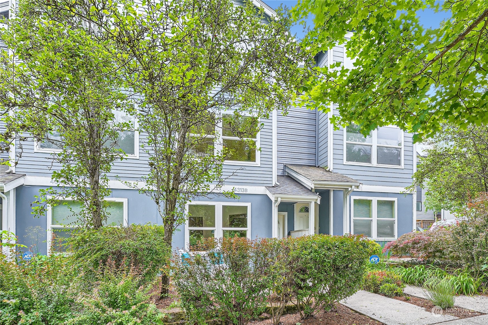 a front view of a house with a garden