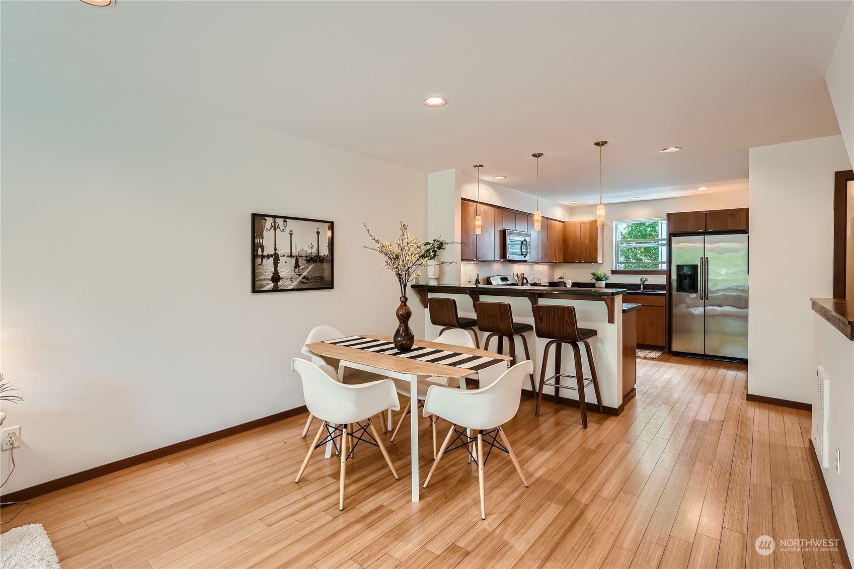 4313 South Webster Street, Unit B Seattle, WA 98118 - Photo 14 of 26 a view of a dining room with furniture and wooden floor